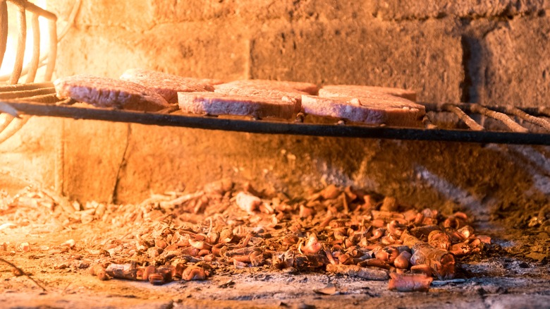 Wood chips and meat in barbecue grill