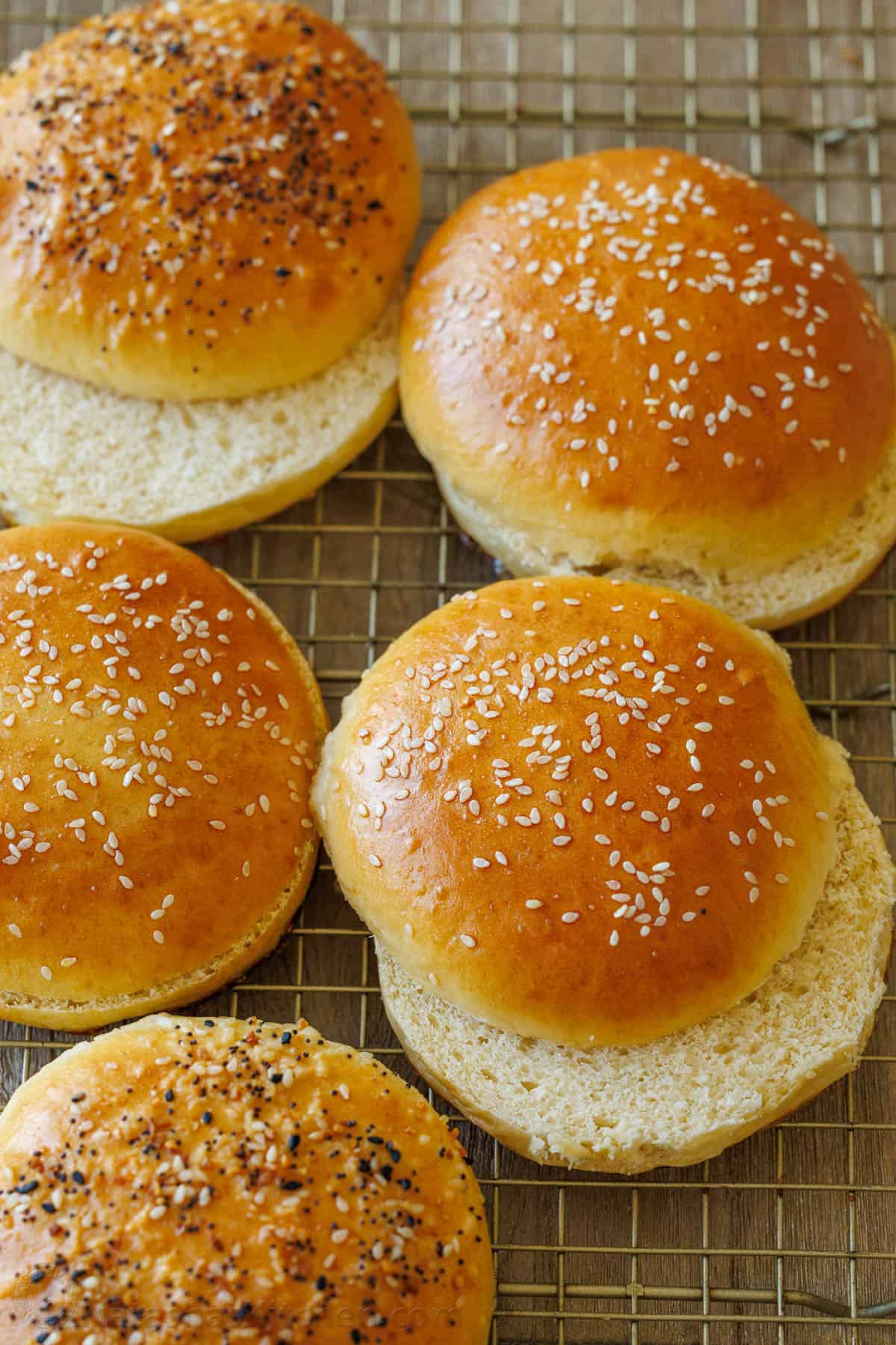 Sliced hamburger buns on a wire cooling rack