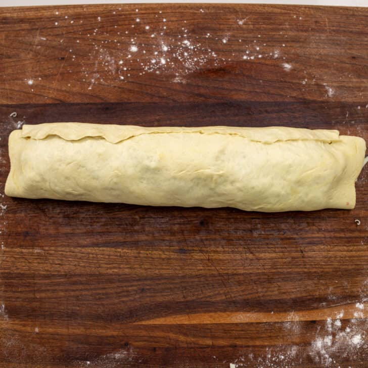 Stromboli tightly rolled into a log with the ends tucked in, before baking