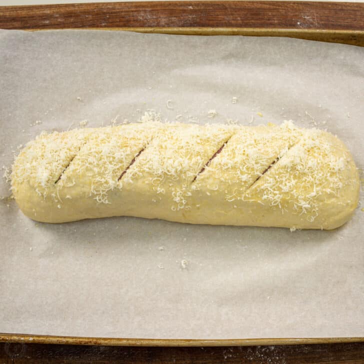 Stromboli rolled and risen with four slits to allow air to escape while baking