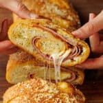 Stromboli sliced into pinwheels showing ham, pepperoni, salami, and cheese