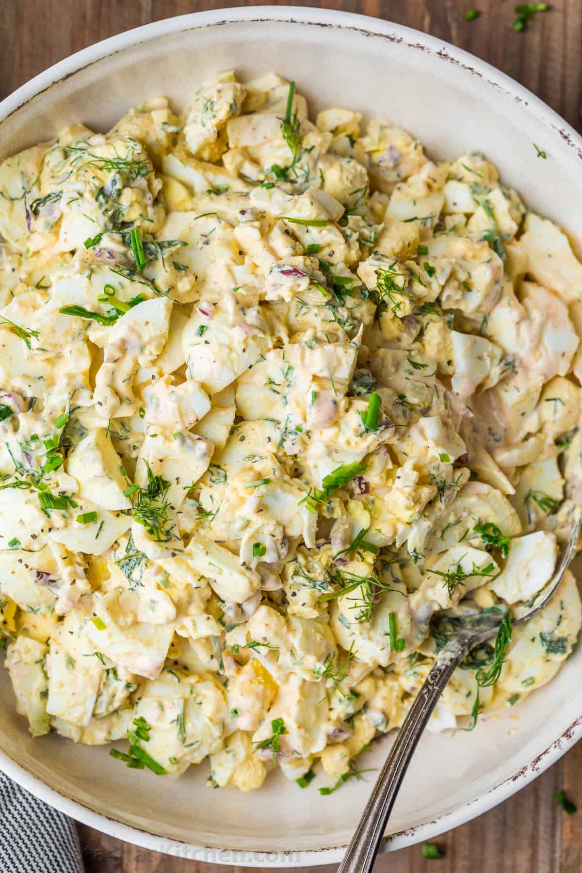 Egg salad with creamy dressing garnished with dill and chives 