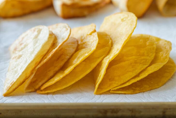 Homemade hard taco shells on paper towels