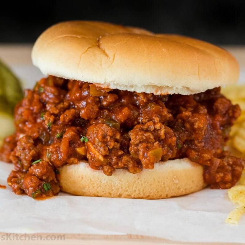 Sloppy Joe sandwich served with chips and pickles