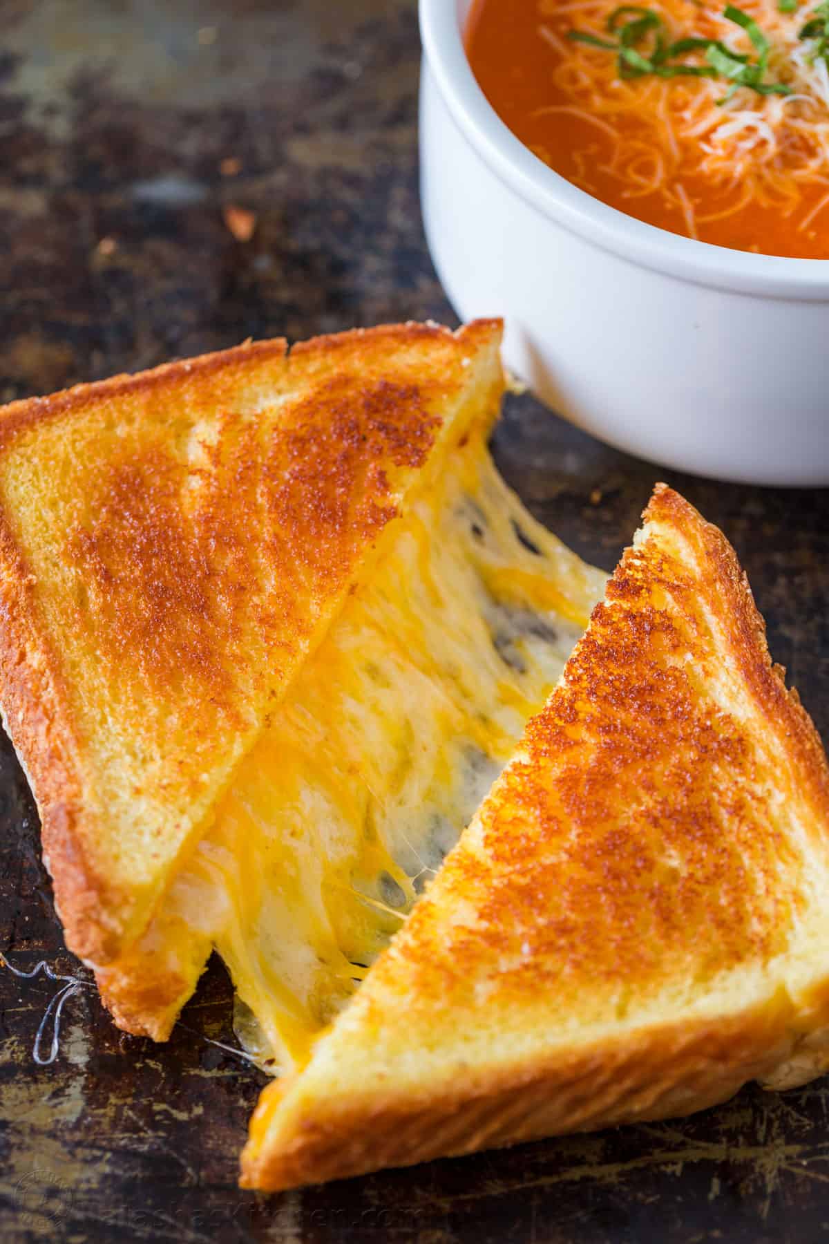 Grilled cheese sandwich served with tomato soup