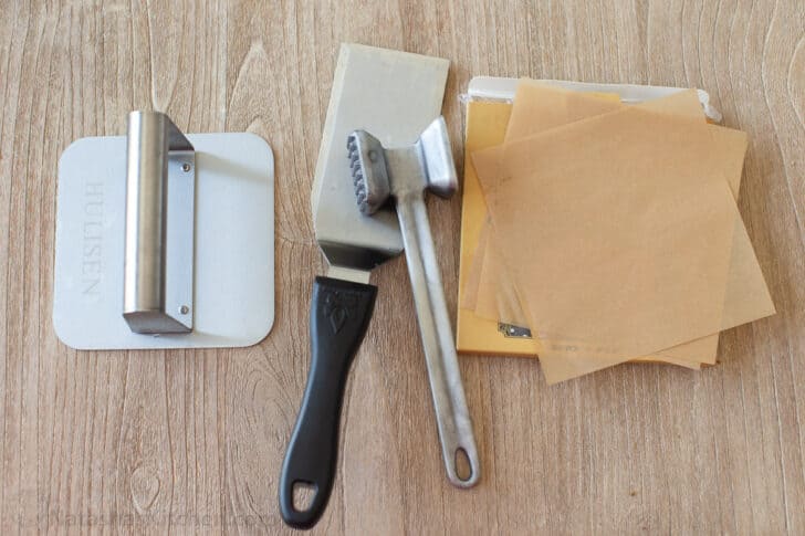 Smash burger press, spatula and parchment paper